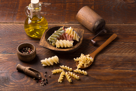 Various mix of pasta on wooden rustic background; Diet and food concept. Colored natural pasta. Spinach, beetroot, eggの写真素材