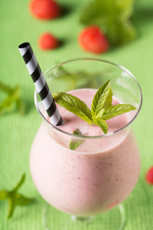 strawberry smoothie over green backgroundの写真素材