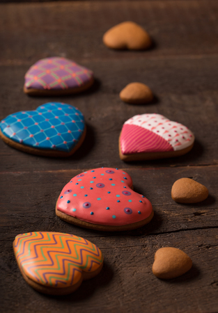 beautiful decorated gingerbread cookies over wooden backgroundの写真素材