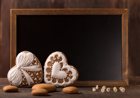 beautiful decorated gingerbread cookies in front of a blackboard の写真素材
