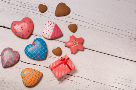 beautiful decorated gingerbread cookies over white wooden backgroundの写真素材
