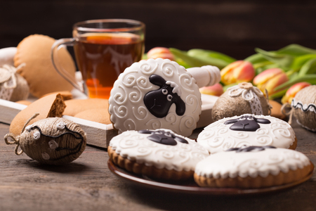 easter table decoration with gingerbread cookies and handmade easter ornamentsの写真素材