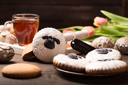 easter table decoration with gingerbread cookies and handmade easter ornamentsの写真素材
