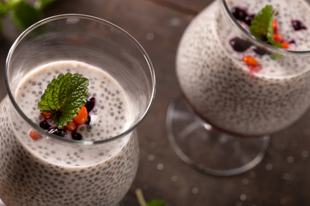 Layered chia seeds pudding with blueberry and seabuckthornの写真素材