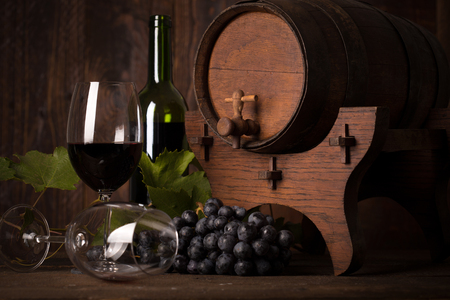 bottle of red wine,grapes and wooden barrelの写真素材