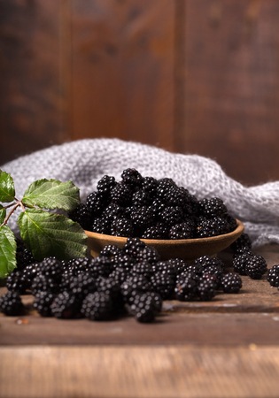blackberry with leaf over wooden backgroundの写真素材