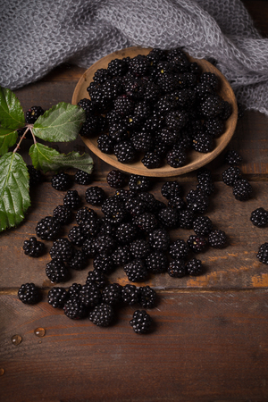 blackberry with leaf over wooden backgroundの写真素材