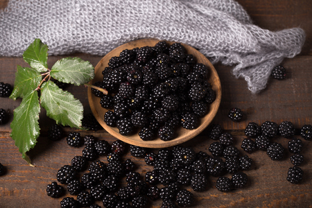 blackberry with leaf over wooden backgroundの写真素材