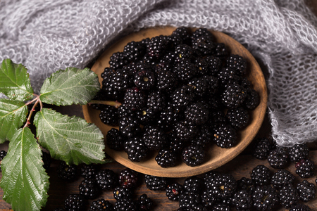 blackberry with leaf over wooden backgroundの写真素材