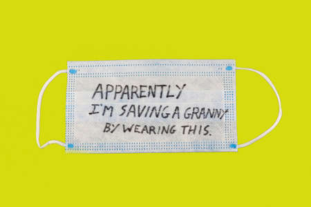 apparently im saving a granny by wearing this drawn on a face mask with yellow background.の写真素材