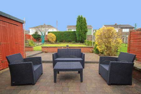 back garden with wicker chairs