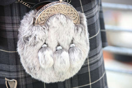 close up of a hairy sporran on a grey coloured kilt.の写真素材