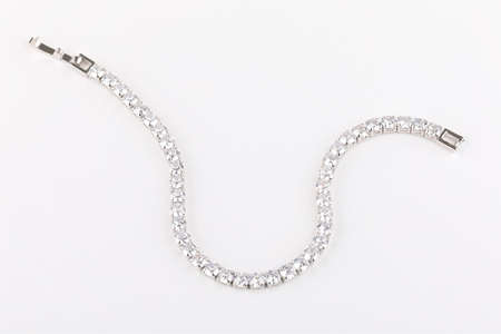 silver bracelet with diamontes and clasps against a white background.の写真素材