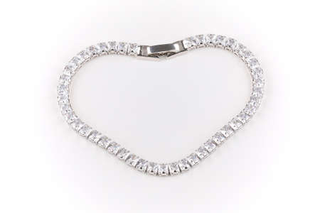 heart shaped silver diamonte bracelet with clasps placed against a white backgroundの写真素材