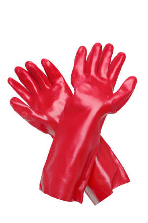 pair of bright red plastic cleaning gloves against a white backgroundの写真素材