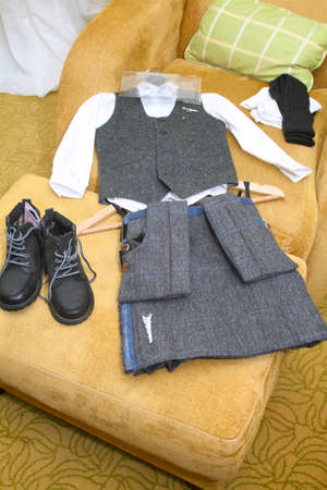 page boy kilt outfit, shirt, socks and shoes laid out on a couch before the wedding.の写真素材