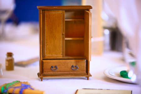 mini sized toy cupboard on the table with mints, glasses and blurred background.の写真素材