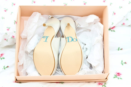 bridal shoes in the box with i do on the soles in diamontesの写真素材
