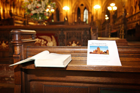 anniversary event programme resting on the church pew with picture of coats memorial church in...