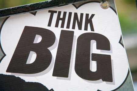 think big message on an outdoors banner in black and white with blurred background effect.の写真素材