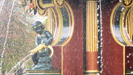 pixie feature water fountain holding golden crocodile with flowing jets of waterの写真素材