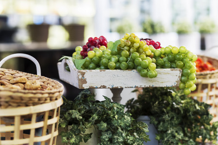 the composition of the basket and grapes on the old trayの写真素材