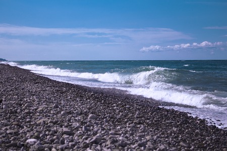 sea with high waves crashing against the shore