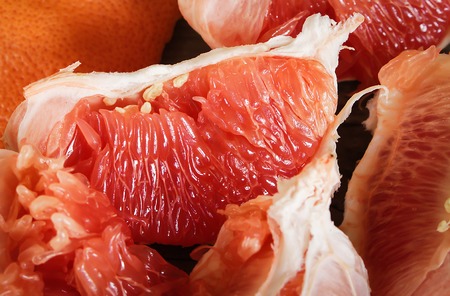 pieces of fresh grapefruit on a wooden table