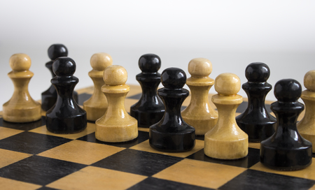 A pawn Board game on a wooden table.の写真素材