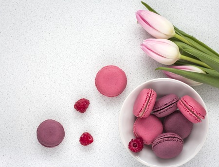 delicate tulips with macaroons on white background.