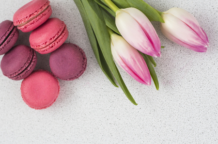festive composition, tulips and macaroons on the table.copy spaceの写真素材