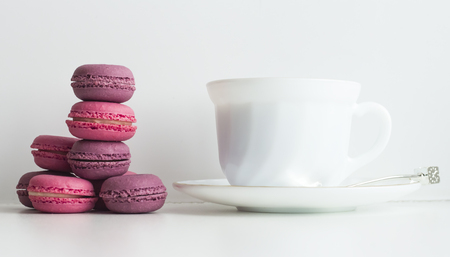 afternoon tea table with colorful macarons and a tea cup.の写真素材