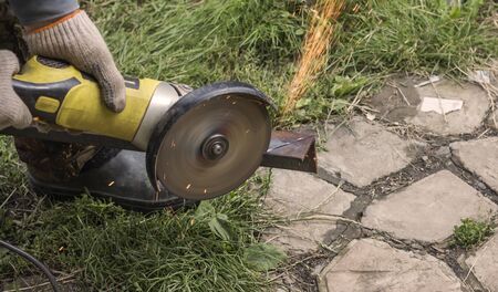 the process of cutting the angle from the iron beam circular saw professional locksmith.