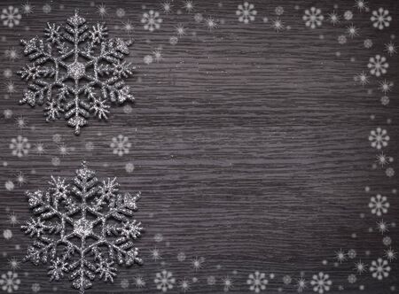 Christmas background with snowflakes on wooden texture with copy space.の写真素材