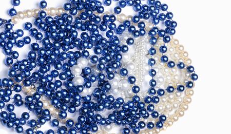 a bunch of blue and white beads on a white backgroundの写真素材