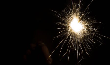bright festive new year Sparkler on a black background with a copy of the space.