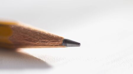 simple pencil on a white background with texture, macro photography.の写真素材