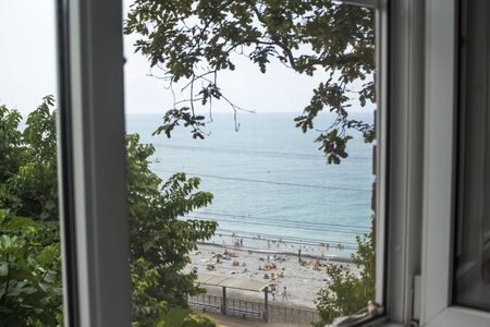 view from the window to the beach and the sea, the concept of a trip to the sea.