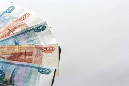 Russian banknotes on a white background in a bright light.