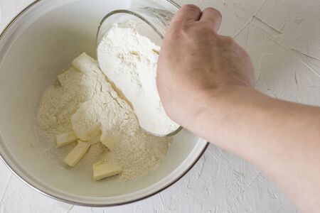 Grinding wheat flour and butter in a pie pan.