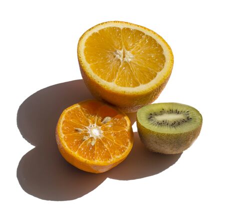 halves of tangerine lime lemon and kiwi isolated on a white background with sun shadows.の写真素材