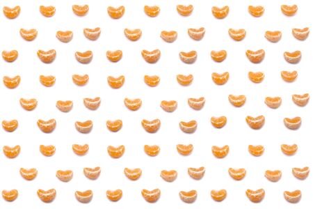 Mandarin slices on a white background. Seamless pattern. Tropical citrus background. Holiday, Christmas and New year concept.の写真素材