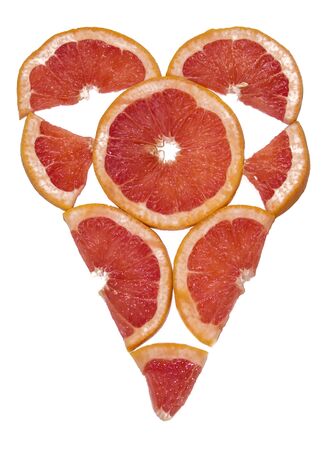 Red fruit heart made from grapefruit slices on a white background.の写真素材