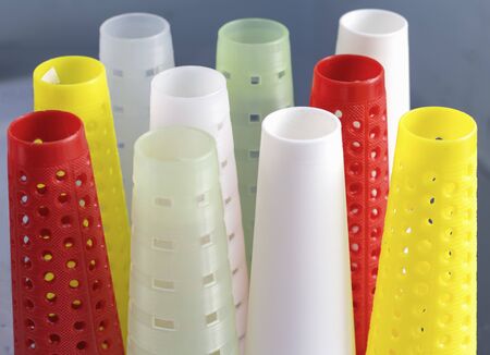 empty colored cones for yarn in knitting production.