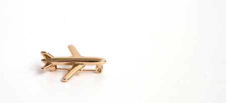 gold brooch in the shape of an airplane on a white background. Women's or men's Accessories.の写真素材
