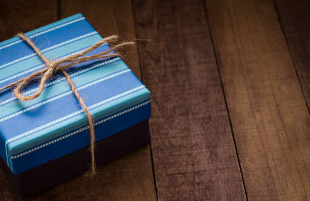 Vintage blue gift box on an old wooden background.
