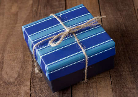 Blue elegant gift box on a wooden background.の写真素材