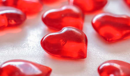 lots of red glass hearts on a white background Valentine's day card.の写真素材