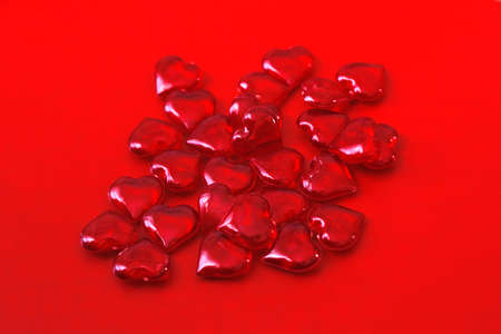 lots of little red hearts on a red background. Valentine's day.