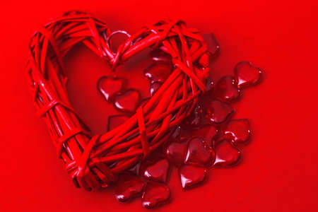 lots of little red hearts and one big one on a red background. Valentine's day.の写真素材